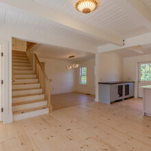 staircase in an extensive renovation transformed an existing c. 1840 Weston home into a warm, refined Vermont retreat