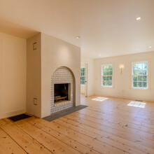 tiled fireplace and living room in an extensive renovation transformed an existing c. 1840 Weston home into a warm, refined Vermont retreat