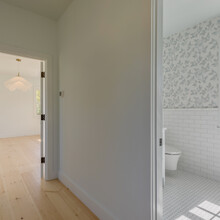 bed and bath of an extensive renovation transformed an existing c. 1840 Weston home into a warm, refined Vermont retreat